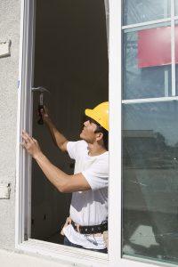 Construction Worker preparing window frame